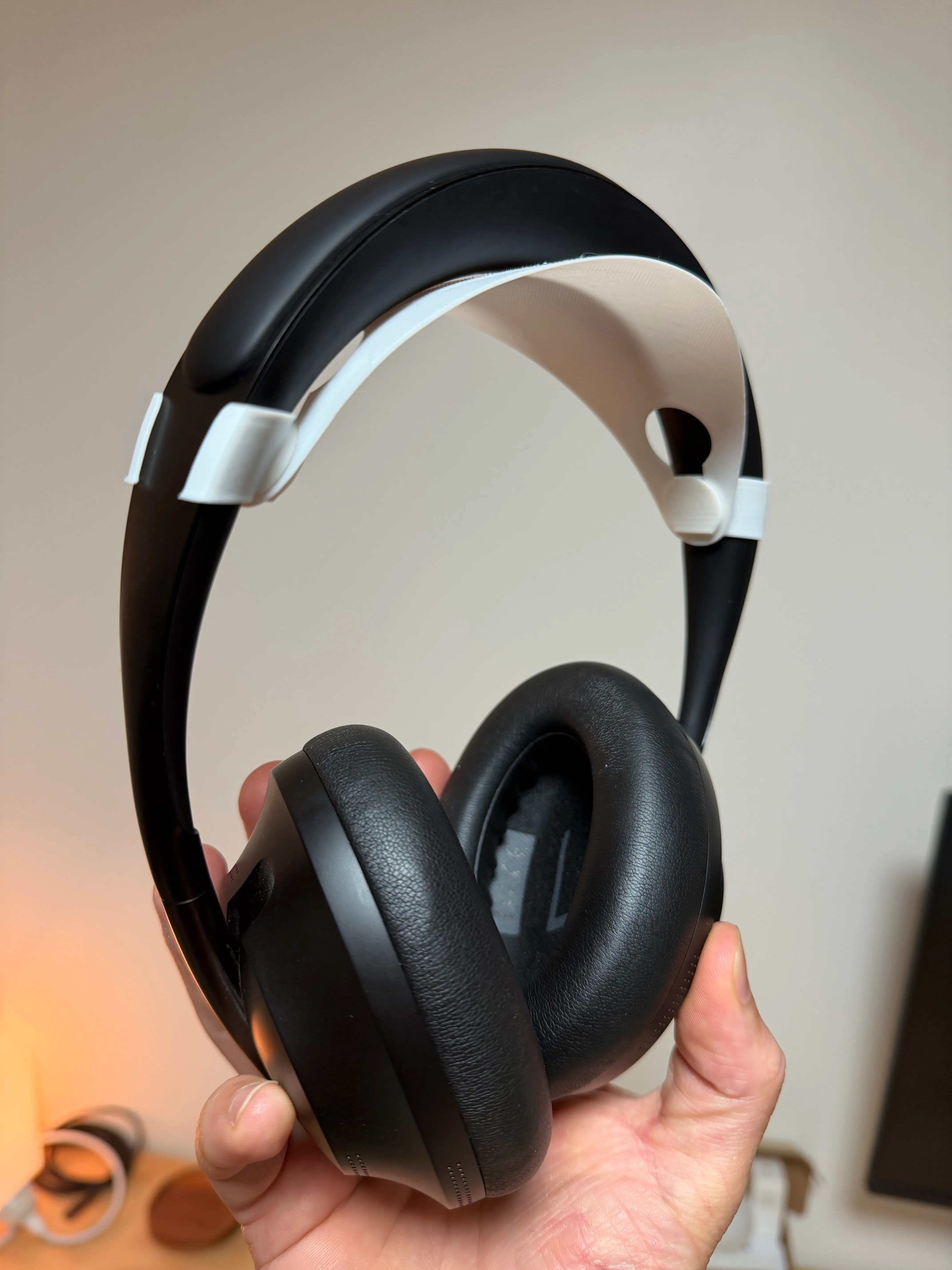 White version of the add-on band showing in more contrast against the black headphones